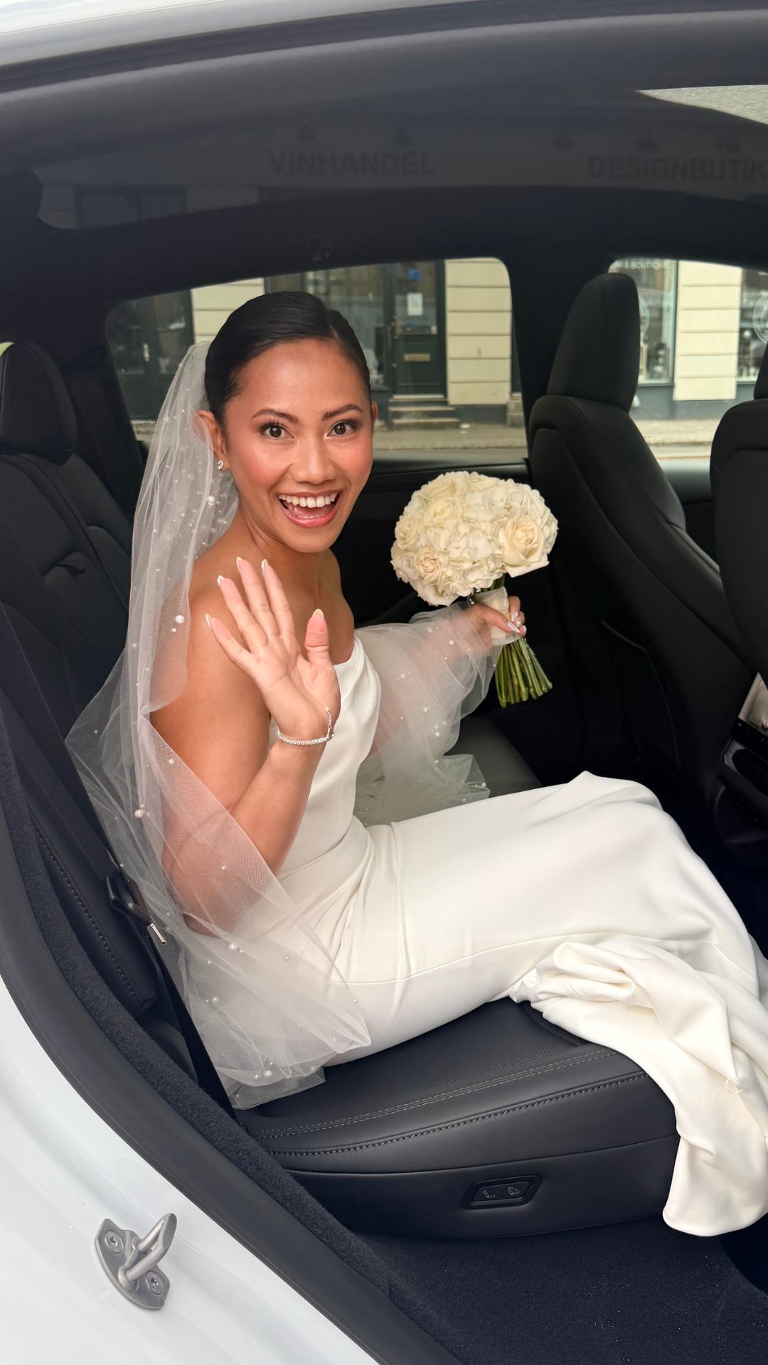 Happy bride styled by IZANEL Copenhagen on her way to the ceremony
